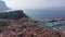 Picturesque aerial view of Cassis cityscape on Mediterranean coast overlooking marina with moored yachts and lighthouse