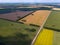 Picturesque aerial view of farmland on multicolored fields with crops sown and grown agriculture ripe for harvest wheat rye and