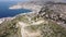 Picturesque aerial view of Saranda city stretching along Albanian coast of Ionian Sea overlooking Lekuresi Castle on