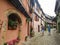 Picturesque alleys of Eguisheim, tipical old houses decorated with flowers, France