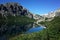 Picturesque alpine lake, Dramatic gray rock mountain reflecting in small calm lake, Laguna Jakob or Jakob lagoon