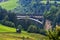 A picturesque Alpine landscape with an old railway bridge.