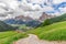 Picturesque alpine road leading to the city Corvara in Badia and Italian Dolomites with a peak Sassongher