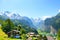 Picturesque Alpine village Wengen, Switzerland. Famous Lauterbrunnen and Staubbach Falls in background. Swiss Alps with snow on