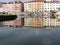 Picturesque ancient residential neighborhood near the city center of Livorno . Tuscany, Italy . Houses and boats are reflected in