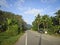 A picturesque asphalt road among low mountains in Thailand. Summer landscape