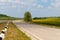 Picturesque asphalt road and sunflower field.