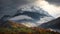 A picturesque autumn landscape, autumn in the Swiss Alps, single houses among the majestic mountains covered in fog. AI