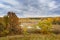 Picturesque autumn landscape. View from the hill to the lowland with forest and swamps. Beautiful natural background