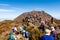 Picturesque autumn view of Unzen Nita Pass trail with rocky volcano Myoken peak and crowd of tourists in Unzen National Park