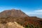 Picturesque autumn view of Unzen Nita Pass trail with rocky volcano peak and clear blue sky in Unzen-Amakusa National Park.