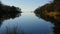 Picturesque autumn water as if a mirror reflects the blue sky