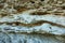 Picturesque background of collapsing surface of limestone rock. Abstract beautiful forms of weathering stone rocks, huge cracks