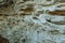 Picturesque background of collapsing surface of limestone rock. Abstract beautiful forms of weathering stone rocks, huge cracks