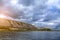 Picturesque bank of the river with clouds over the water.