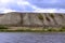 Picturesque bank of the river with clouds over the water.