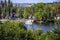 Picturesque bay surrounded by green trees. An old tugboat moored at the pier