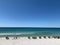 Picturesque beach scene with pristine turquoise waters, beach chairs, and umbrellas