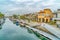 Picturesque canal with boats and docks along walkways and houses in Long Beach