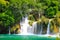 A picturesque cascade waterfall among large stones in the Krka National Landscape Park, Croatia in spring or summer. The beautiful