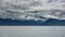 Picturesque clouds swirl over the coastal mountains