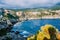 Picturesque coastline in Assos village, Kefalonia island Greece. Colorful houses nestled into the cliff. Summer vacation