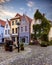 Picturesque cobblestone street in a quaint town lined with brightly colored traditional buildings.