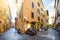 Picturesque, colorful cobblestone street with shops in the Trastevere district of Rome Italy.