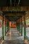 A picturesque corridor leading to the gazebo, richly decorated with paintings on wood