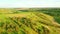 Picturesque countryside with green hills on a sunny day from a bird`s eye view. Filmed in UHD 4k video