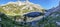 Picturesque crystal clear mountain lake surrounded with peaks.