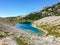 Picturesque crystal clear mountain lake surrounded with peaks.