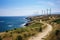 A picturesque dirt road winds down a gentle slope as it runs parallel to the beautiful ocean, View from Cape Kaliakra to an