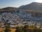 Picturesque drone view of amazing houses of small settlement located near wonderful hills on sunny day.