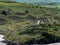 Picturesque dunes with shrubs and hills in the Ireland. European seaside landscape. Nature of Ireland