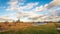 Picturesque Dutch polder landscape with white clouds against a blue sky