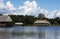 Picturesque and exotic lagoon with clean water El Milagro, loggon milagros with wooden house and thatched roof stilt houses Amazon