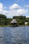 Picturesque and exotic lagoon with clean water El Milagro, loggon milagros with wooden house and thatched roof stilt houses Amazon