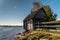 A picturesque fishing house with a washed-out Foundation on the Bank of the Volkhov river at the exit to lake Ladoga