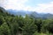 The picturesque foothills of the Alps, the lake surrounded with the low rocks overgrown with the dense wood are visible the old ca