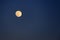 Picturesque full moon against a blue sky. Full planet moon with craters, text space. Night landscape for weather forecast