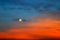 Picturesque Full moon on a background of beautiful blue and red clouds. Clouds at sunset, sunrise during the full moon. Cloud