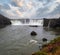 Picturesque full of water big waterfall Godafoss autumn dull day view, north Iceland