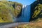 Picturesque full of water big waterfall Skogafoss autumn view, southwest Iceland