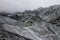 Picturesque Glacier Peaks Jutting Through A Cloudy Sky