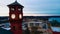 Picturesque Glowing Clock Tower overlooking a rural lakeside community