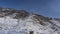 A picturesque harsh mountain range against a clear blue sky.