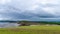 Picturesque hills in the south of Ireland, a view of the Clonakilty seashore. Cloudy, rainy weather. Landscapes along the Wild