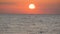 Picturesque huge round red sunset or dawn at sea sun over water surface. Reflected in sea sun ray and sunrise over the