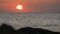 Picturesque huge round red sunset or dawn at sea sun over water surface. Reflected in sea sun ray and sunrise over the